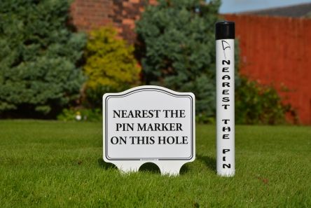 nearest the pin marker with sign